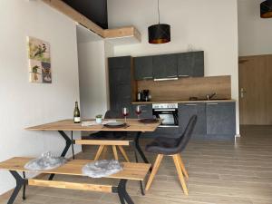 a kitchen with a wooden table and a dining room at Apartment Bienenfresser in Vogtsburg