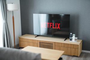 a television sitting on top of a wooden stand at Crescout Toa 1 in Gotemba