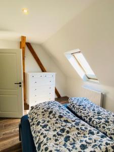 a bedroom with two beds and a skylight at HaRE Ferienwohnung DREE in Langeneß +22 photos