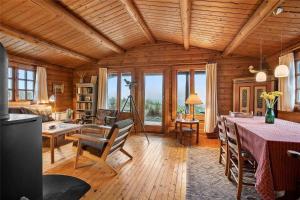 a living room with wooden ceilings and a table and chairs at LN1500-Hirtshals-Kranken-11 in Hirtshals