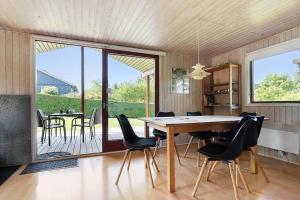 a dining room with a table and chairs at SJ299-Hejlsminde-Poppelvaenget-4 in Hejlsminde