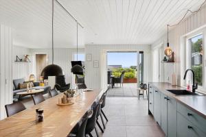 a kitchen with a long table and a dining room at SJ302-Haderslev-Blokhusskoven-63 in Haderslev