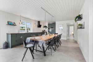 a kitchen and dining room with a table and chairs at SJ302-Haderslev-Blokhusskoven-63 in Haderslev +16 photos