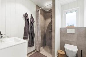a bathroom with a shower and a toilet and a sink at SJ302-Haderslev-Blokhusskoven-63 in Haderslev