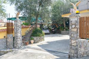 a house with a gate and a parking lot with a car at Casa Vacanze Chery in Sorrento