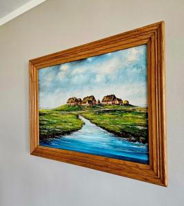 a picture of a painting of a river and houses at HaRE Ferienwohnungen Käptn Magda in Langeneß