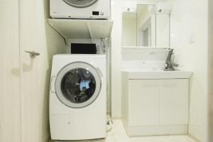 a washing machine in a bathroom next to a sink at Crescout Toa 1 in Gotemba