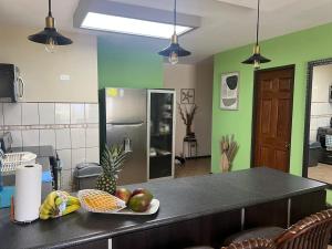 a kitchen with a plate of fruit on a counter at Tropical Stay in Coco in Coco