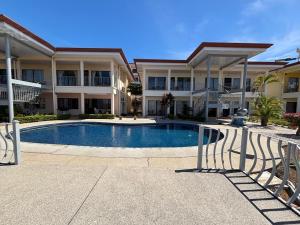 a swimming pool in front of a large building at Tropical Stay in Coco in Coco
