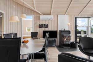 a dining room with a table and chairs and a fireplace at SJ301-Hejls-Teglgardsvej-3 in Hejls