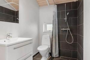 a bathroom with a shower and a toilet and a sink at SJ301-Hejls-Teglgardsvej-3 in Hejls +19 photos