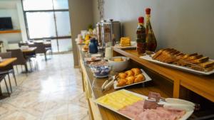 a buffet line with different types of food on at Altezza Apart Suites in Mendoza