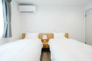 two beds sitting next to each other in a bedroom at Crescout Toa 1 in Gotemba +73 photos