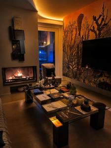 a living room with a fireplace and a tv at Villa Silvio Relais in Civitanova Alta