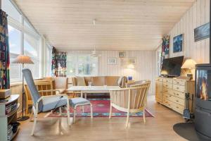 a living room with a table and chairs at LN1971-Lonstrup-Kirkedalsvej-7 in Lønstrup