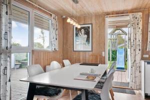 a dining room with a white table and chairs at SJ310-Hejls-Ronnebaervaenget-14 in Hejls