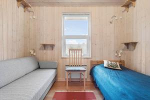 a room with a couch and a chair and a window at LN1971-Lonstrup-Kirkedalsvej-7 in Lønstrup
