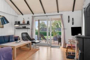 a living room with a couch and a table at SJ311-Hejls-Slaenvaenget-9 in Hejls