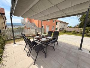 a table and chairs sitting on a patio at Apartment Aurora in Ankaran