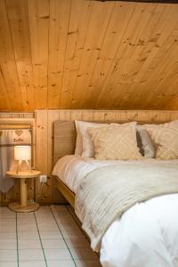 a bedroom with a bed with a wooden ceiling at Renovated Triplex House 8 guests Orelle in Orelle