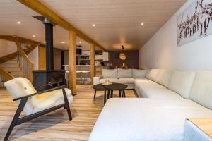 a living room with a couch and a fireplace at Renovated Triplex House 8 guests Orelle in Orelle +30 photos