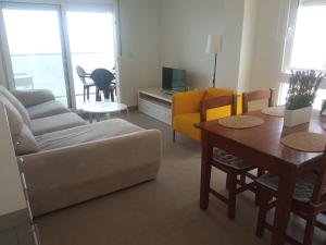 a living room with a couch and a table at BEACH SUN SPIRIT, spa & gym in La Manga del Mar Menor