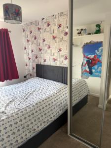 a bedroom with a mirror next to a bed at The Pentland Escape in Roslin