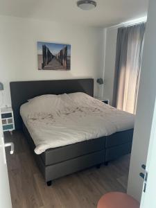 a bedroom with a bed in a room at Green Flower in Renesse