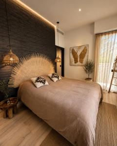 a bedroom with a large bed and a brick wall at Superbe Villa très proche cannes in Mougins +43 photos