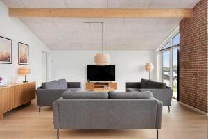 a living room with two couches and a tv at SJ313-Borkop-Sommerhaven-38 in Mørkholt