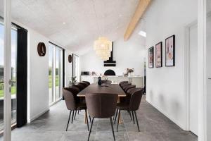a dining room with a table and chairs at SJ313-Borkop-Sommerhaven-38 in Mørkholt