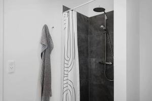 a bathroom with a shower with a glass door at SJ313-Borkop-Sommerhaven-38 in Mørkholt +25 photos