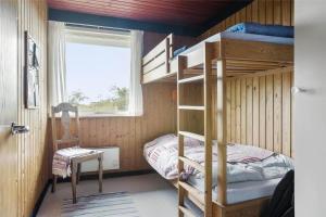 a bedroom with a bunk bed and a chair at LN76740-Hjorring-Sostjernevej-11 in Hjørring