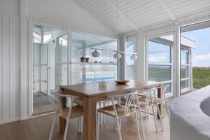 a dining room with a wooden table and chairs at LN1802-Hjorring-Bovlingbjergvej-4 in Hjørring +22 photos