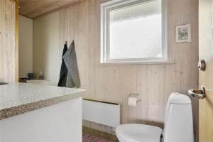 a bathroom with a white toilet and a window at LN76740-Hjorring-Sostjernevej-11 in Hjørring +12 photos