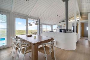a kitchen and dining room with a table and chairs at LN1802-Hjorring-Bovlingbjergvej-4 in Hjørring