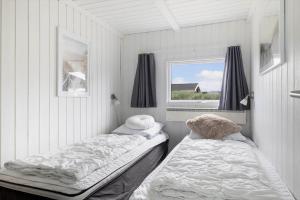 a room with two beds in it with a window at LN1802-Hjorring-Bovlingbjergvej-4 in Hjørring