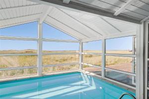 a swimming pool in a house with windows at LN1802-Hjorring-Bovlingbjergvej-4 in Hjørring