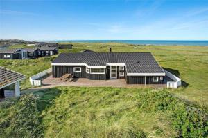 a house on a hill with the ocean in the background at LN1802-Hjorring-Bovlingbjergvej-4 in Hjørring