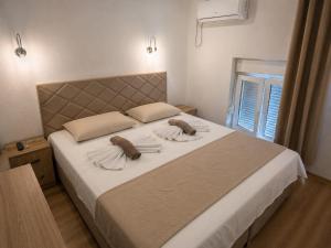 a bedroom with a large bed with two pillows on it at Rooms & Spa BJELASICA in Bijelo Polje