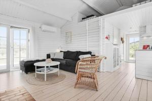 a living room with a couch and a table at LN1883-Hjorring-Revlingrenden-13 in Hjørring