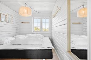 a room with two beds and a mirror at LN1883-Hjorring-Revlingrenden-13 in Hjørring