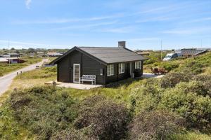 a small house sitting on top of a hill at LN1883-Hjorring-Revlingrenden-13 in Hjørring