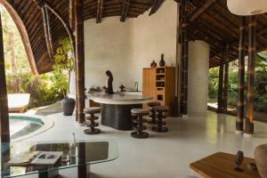a kitchen with a island in the middle of a house at Kaymana in Uluwatu