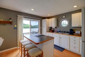 a kitchen with white cabinets and a table with chairs at Fire Pit & Floating Dock! Claytor Lake Hideout in Draper +22 photos