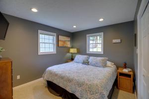a bedroom with a bed and two windows at Fire Pit & Floating Dock! Claytor Lake Hideout in Draper
