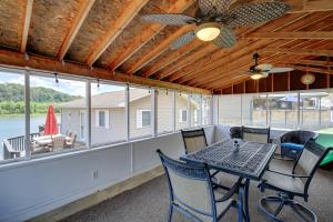 a screened porch with a table and chairs and windows at Fire Pit & Floating Dock! Claytor Lake Hideout in Draper