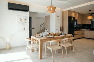 a kitchen and dining room with a wooden table and chairs at Villas Pasha in Faliraki +58 photos