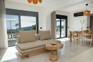 a living room with a couch and a table at Villas Pasha in Faliraki