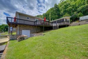 a house with two decks and a grassy hill at Fire Pit & Floating Dock! Claytor Lake Hideout in Draper